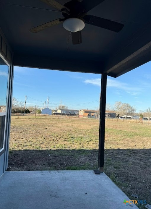 view of yard with a patio area and ceiling fan