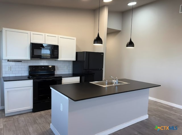 kitchen with black appliances, decorative light fixtures, white cabinetry, and sink