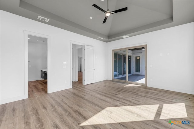 105 Gillespie Ct, Horseshoe Bay, TX 78657 - spare room featuring a ceiling fan, light wood-style flooring, a tray ceiling, and baseboards