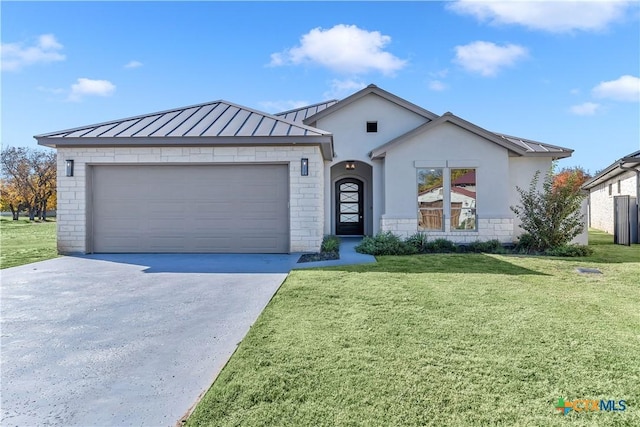 105 Gillespie Ct, Horseshoe Bay, TX 78657 - view of front of house featuring a standing seam roof, concrete driveway, a front lawn, and an attached garage