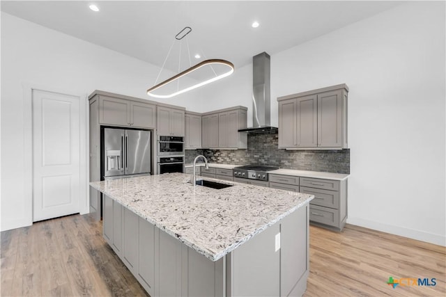 105 Gillespie Ct, Horseshoe Bay, TX 78657 - kitchen featuring gray cabinetry, appliances with stainless steel finishes, wall chimney range hood, and recessed lighting