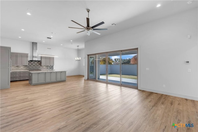 105 Gillespie Ct, Horseshoe Bay, TX 78657 - unfurnished living room featuring a ceiling fan, light wood-style flooring, recessed lighting, a sink, and baseboards