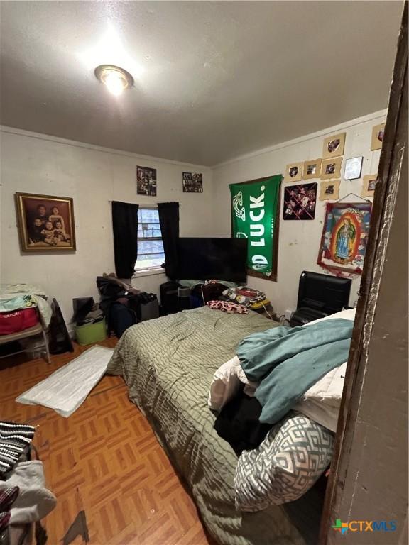 bedroom with ornamental molding