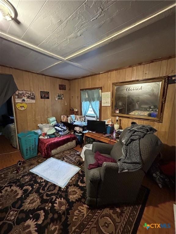 living room featuring lofted ceiling, wooden walls, and wood finished floors