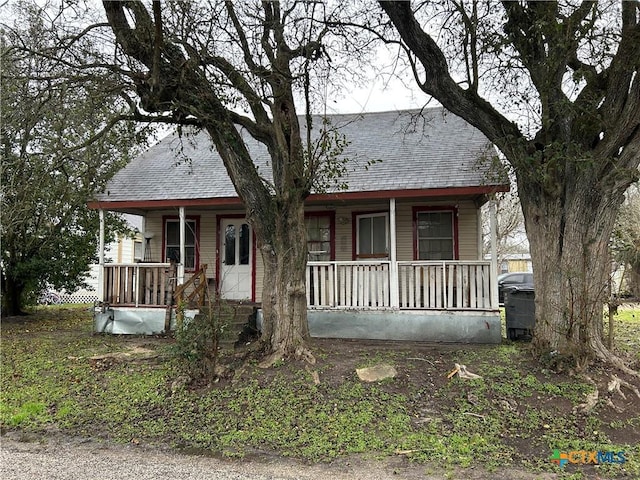 view of front of house featuring a shingled roof and a porch