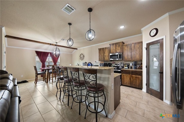 6105 Dorado Dr, Killeen, TX 76542 - kitchen with visible vents, a kitchen bar, crown molding, a center island with sink, and stainless steel appliances