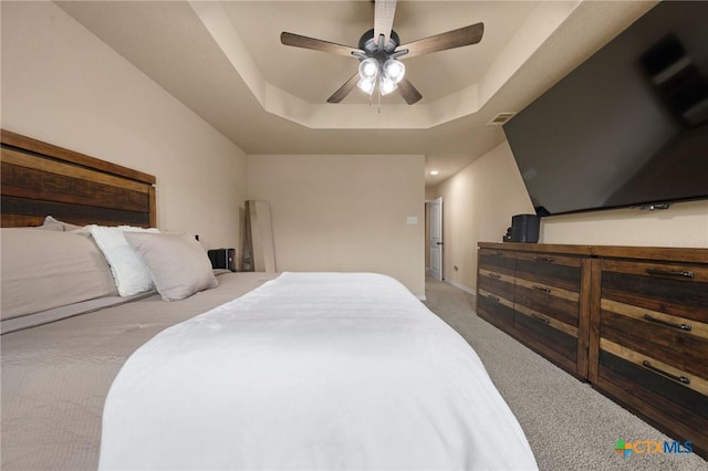 6105 Dorado Dr, Killeen, TX 76542 - carpeted bedroom with ceiling fan, a raised ceiling, baseboards, and visible vents
