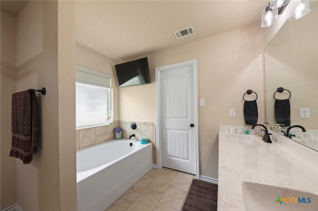 6105 Dorado Dr, Killeen, TX 76542 - full bath featuring visible vents, a sink, tile patterned flooring, a garden tub, and double vanity