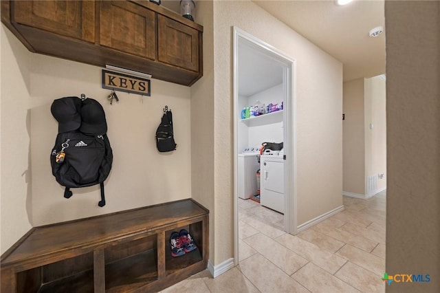 6105 Dorado Dr, Killeen, TX 76542 - mudroom with washing machine and dryer, baseboards, and light tile patterned floors