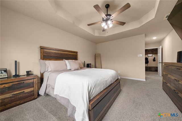 6105 Dorado Dr, Killeen, TX 76542 - bedroom with a ceiling fan, visible vents, baseboards, a raised ceiling, and light carpet
