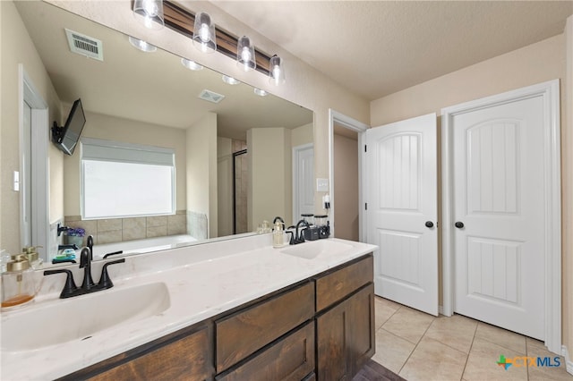 6105 Dorado Dr, Killeen, TX 76542 - full bath with double vanity, visible vents, tile patterned flooring, and a sink