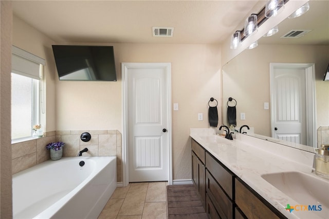 6105 Dorado Dr, Killeen, TX 76542 - bathroom featuring a bath, tile patterned floors, visible vents, and a sink