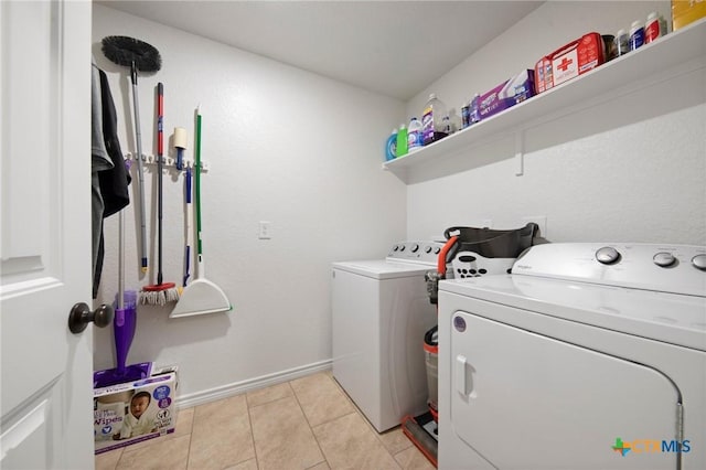6105 Dorado Dr, Killeen, TX 76542 - laundry room with baseboards, washing machine and dryer, laundry area, and light tile patterned floors