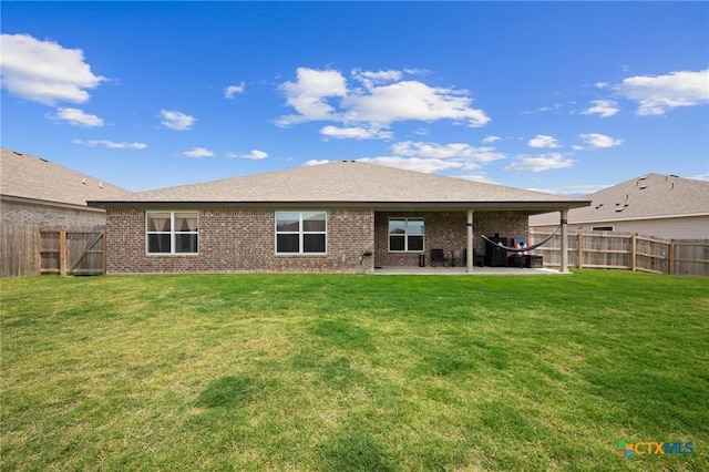 6105 Dorado Dr, Killeen, TX 76542 - rear view of property with a patio, brick siding, a lawn, and a fenced backyard