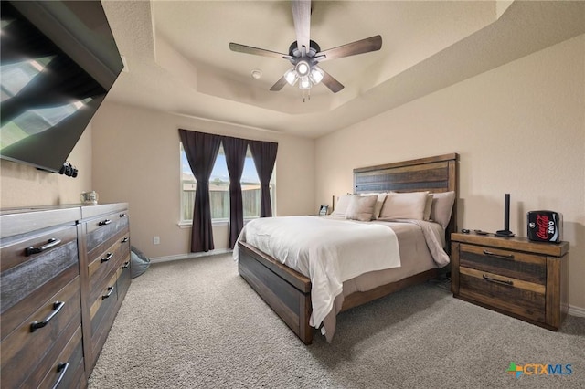 6105 Dorado Dr, Killeen, TX 76542 - bedroom with baseboards, a raised ceiling, light carpet, and ceiling fan