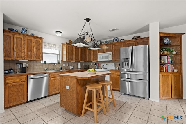 1712 Indian Camp Trl, Copperas Cove, TX 76522 - kitchen with appliances with stainless steel finishes, light tile patterned floors, backsplash, and light countertops