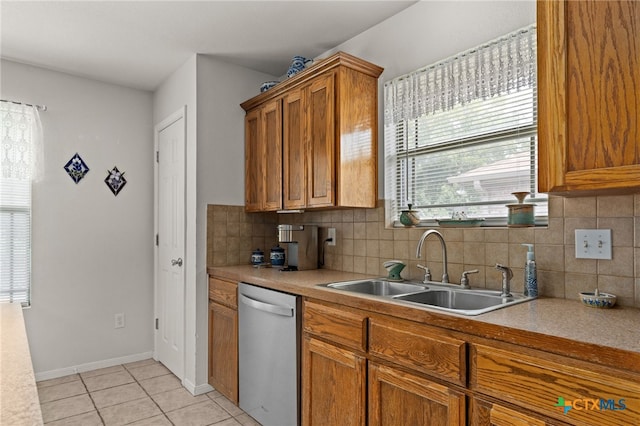 1712 Indian Camp Trl, Copperas Cove, TX 76522 - kitchen featuring stainless steel dishwasher, brown cabinetry, light countertops, light tile patterned floors, and tasteful backsplash