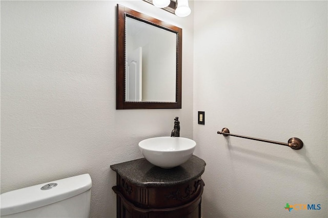 bathroom featuring toilet and vanity