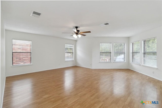 empty room with light hardwood / wood-style floors and ceiling fan