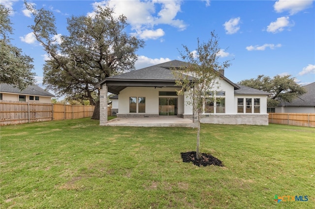 rear view of house featuring a lawn, ceiling fan, and a patio area