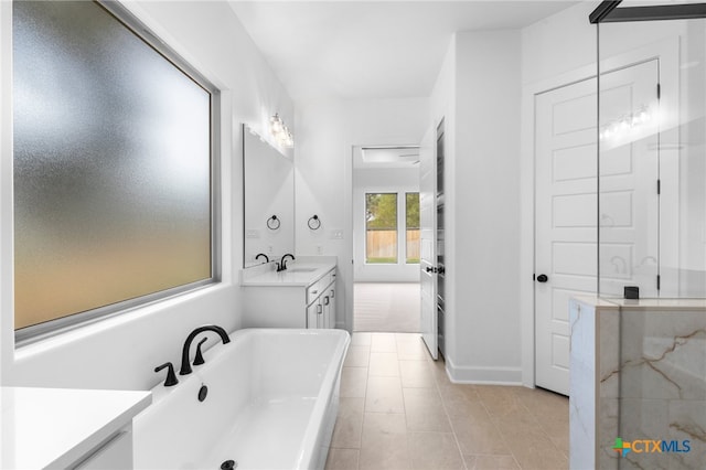 bathroom with tile patterned flooring, vanity, and plus walk in shower