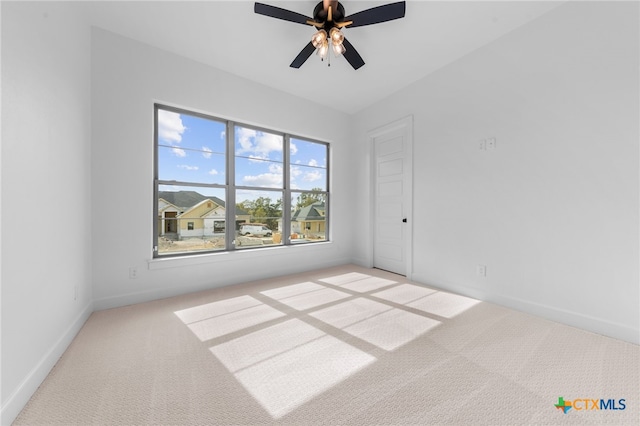 unfurnished room with light carpet and ceiling fan