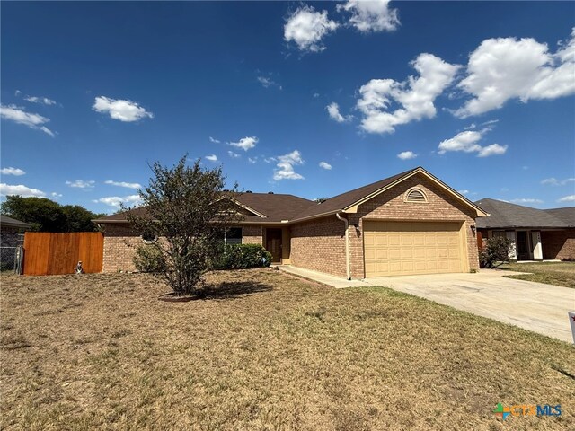 single story home with a garage and a front yard