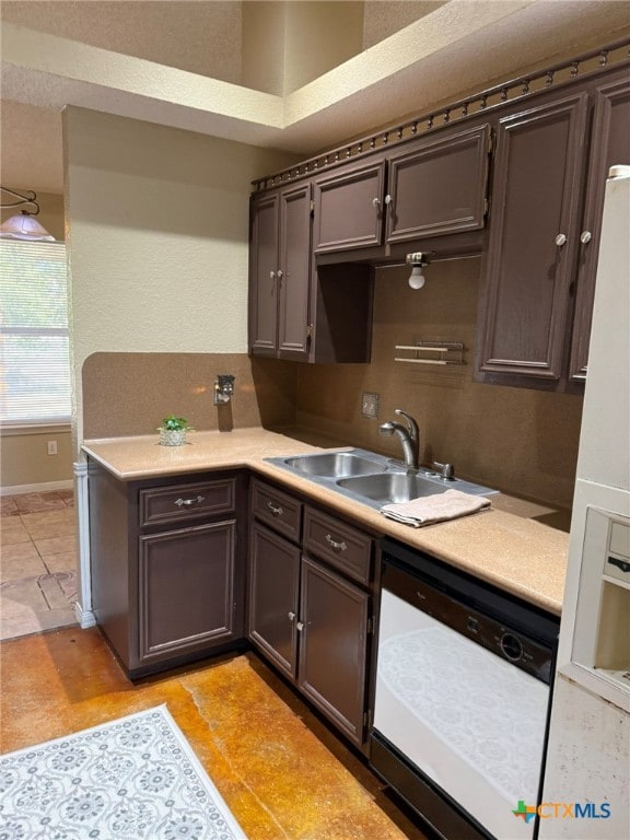 kitchen featuring dishwasher, dark brown cabinetry, and sink