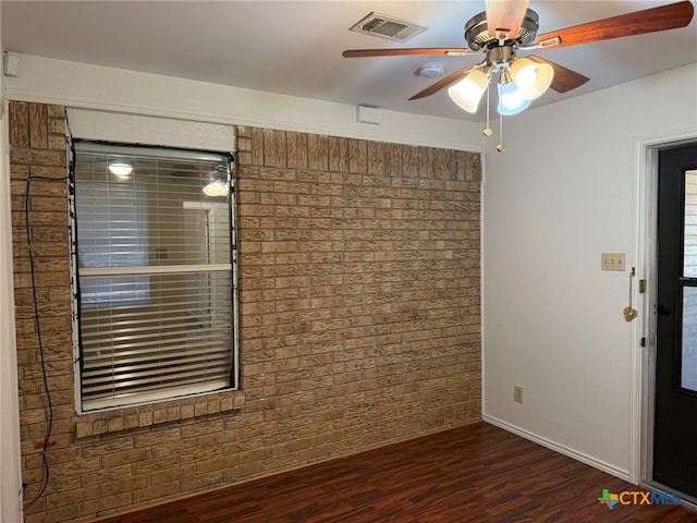 spare room with dark wood-type flooring and ceiling fan