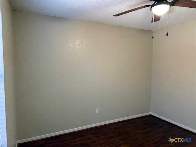 empty room with dark wood-type flooring, a textured ceiling, and ceiling fan