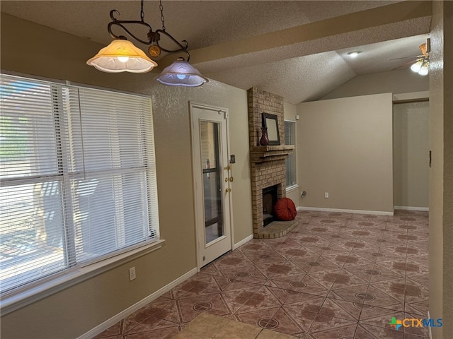 interior space featuring tile patterned flooring, ceiling fan, a textured ceiling, a brick fireplace, and vaulted ceiling