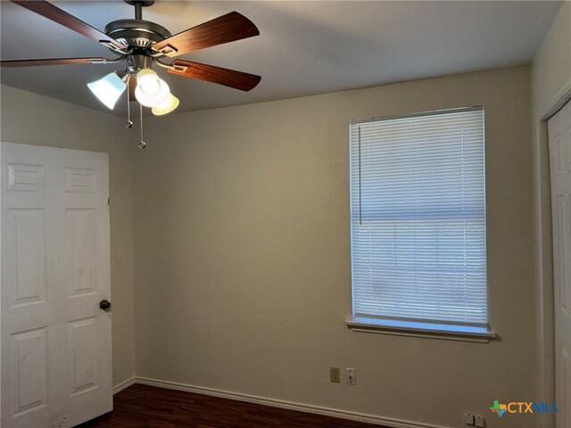 unfurnished bedroom featuring dark wood-type flooring and ceiling fan