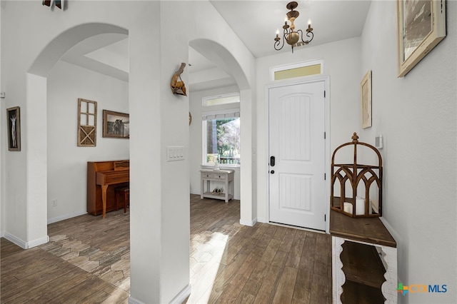 1882 Rush Crk, Canyon Lake, TX 78133 - entryway with wood finished floors, arched walkways, a chandelier, and baseboards