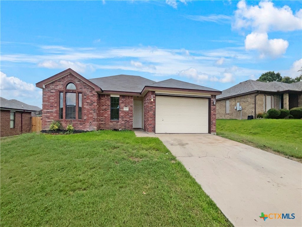 single story home with a garage and a front yard