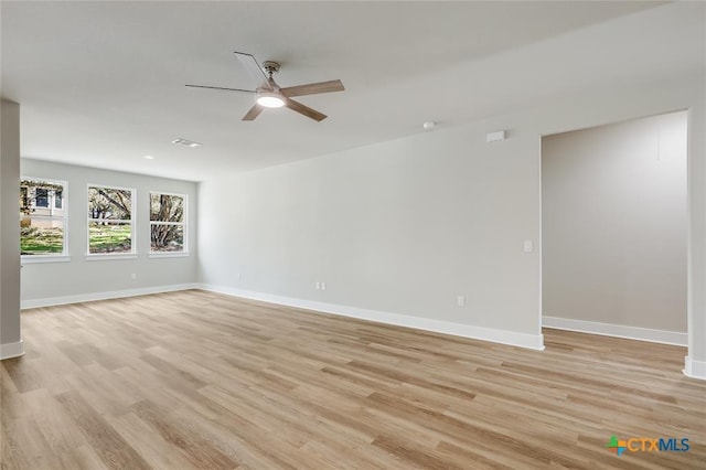 empty room with ceiling fan and light wood-type flooring