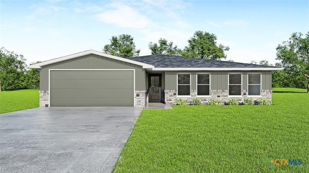 view of front of house featuring a front lawn and a garage