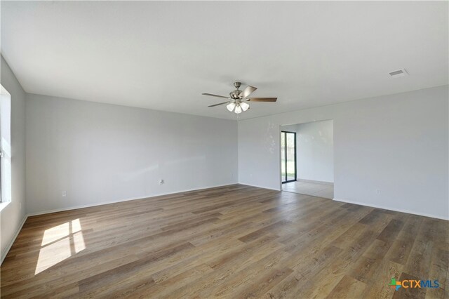 2703 Casey Dr, Killeen, TX 76543 - empty room with wood finished floors, ceiling fan, and baseboards