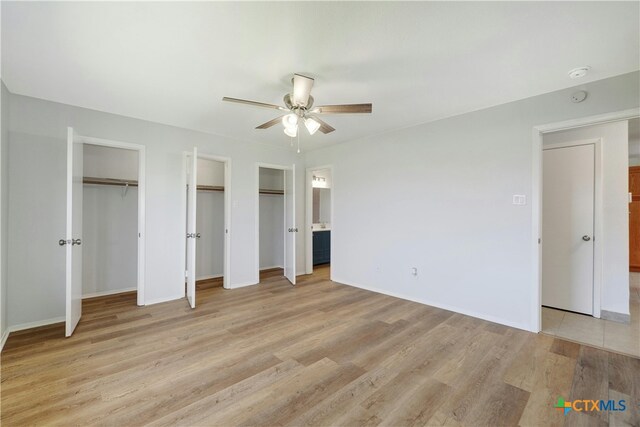 2703 Casey Dr, Killeen, TX 76543 - unfurnished bedroom with multiple closets, light wood finished floors, baseboards, and a ceiling fan