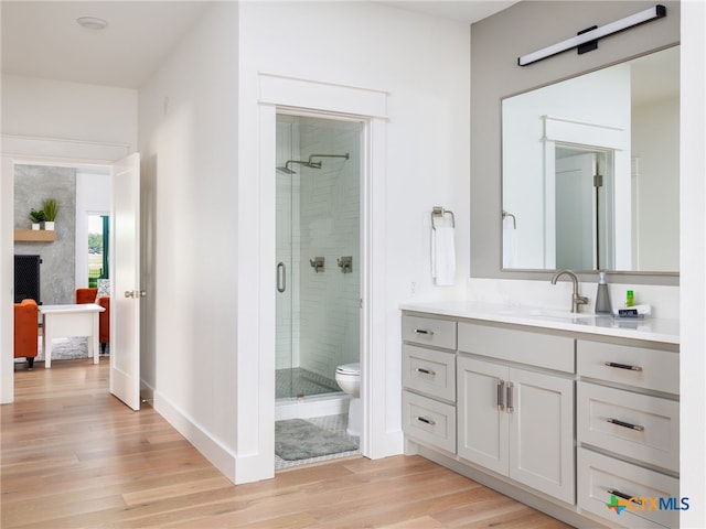 3415 Chisholm Trl, Salado, TX 76571 - bathroom with a shower stall, vanity, toilet, and wood finished floors
