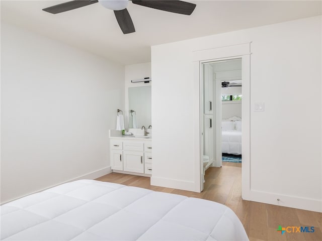 3415 Chisholm Trl, Salado, TX 76571 - bedroom with a sink, light wood finished floors, baseboards, and ceiling fan