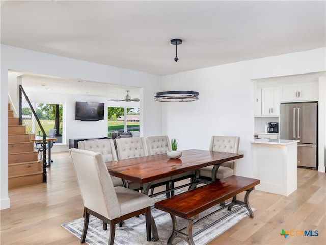 3415 Chisholm Trl, Salado, TX 76571 - dining space with stairs, a ceiling fan, and light wood-style floors