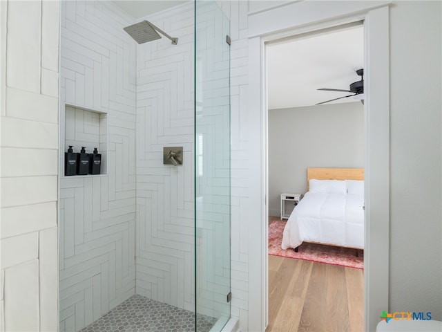 3415 Chisholm Trl, Salado, TX 76571 - ensuite bathroom with ensuite bath, wood finished floors, a stall shower, and ceiling fan