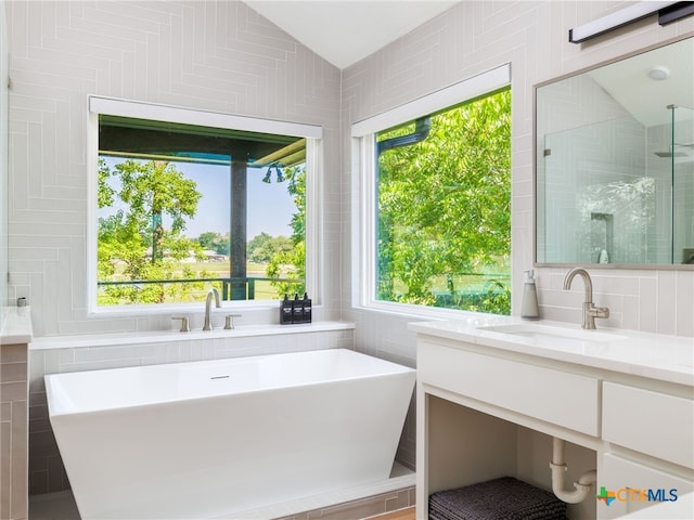 3415 Chisholm Trl, Salado, TX 76571 - bathroom with lofted ceiling, tiled shower, a soaking tub, and vanity