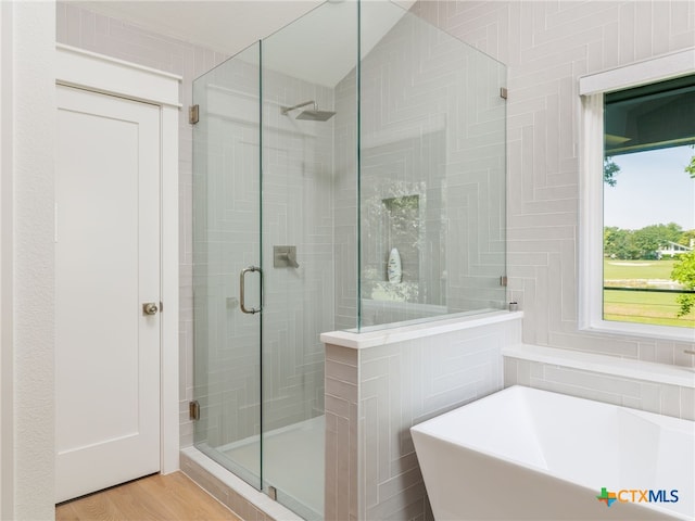 3415 Chisholm Trl, Salado, TX 76571 - full bath with wood finished floors, a shower stall, and a freestanding tub