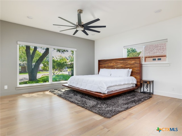 3415 Chisholm Trl, Salado, TX 76571 - bedroom featuring ceiling fan, wood finished floors, baseboards, and multiple windows