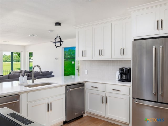 3415 Chisholm Trl, Salado, TX 76571 - kitchen with a sink, white cabinetry, open floor plan, light countertops, and appliances with stainless steel finishes