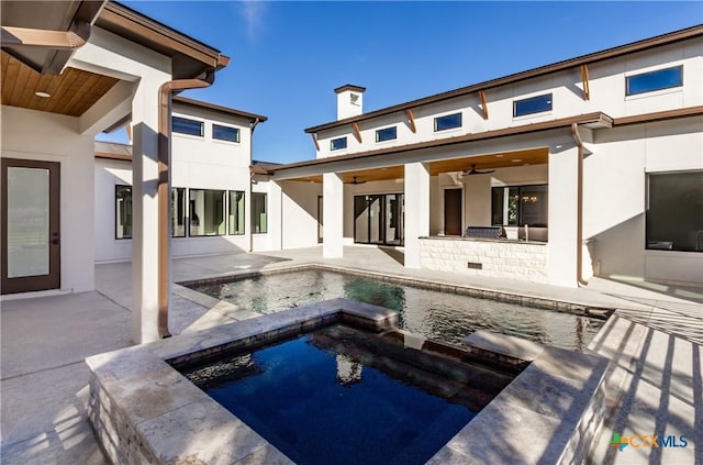 back of property featuring a ceiling fan, a pool with connected hot tub, a patio area, and stucco siding