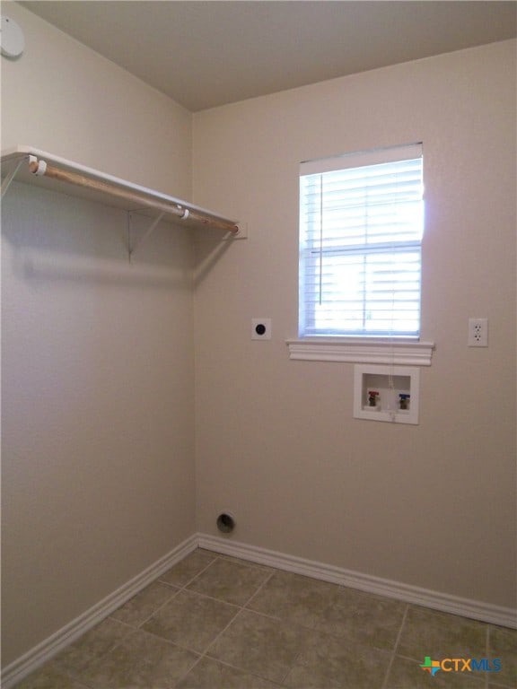 laundry room featuring hookup for a washing machine, electric dryer hookup, and tile patterned floors