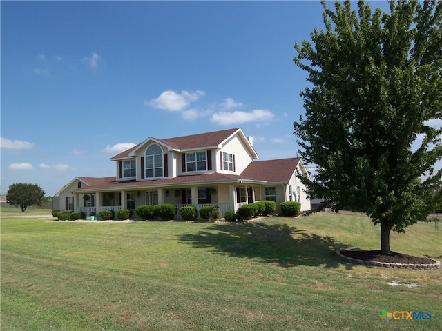 view of front of property with a front yard and covered porch