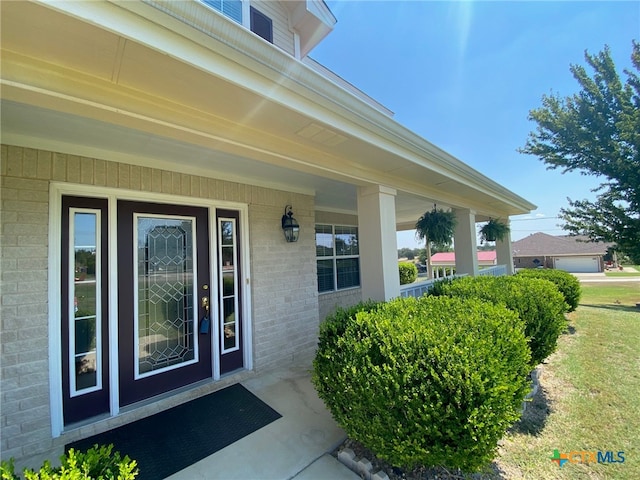 doorway to property with covered porch